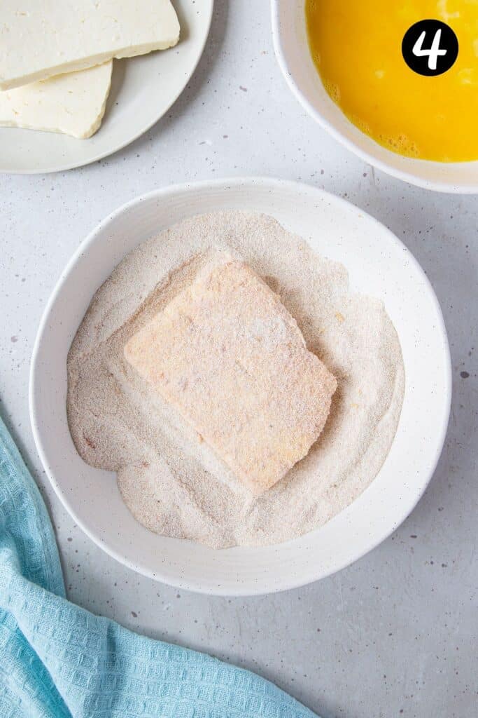 halloumi in a bowl, coated in semolina.