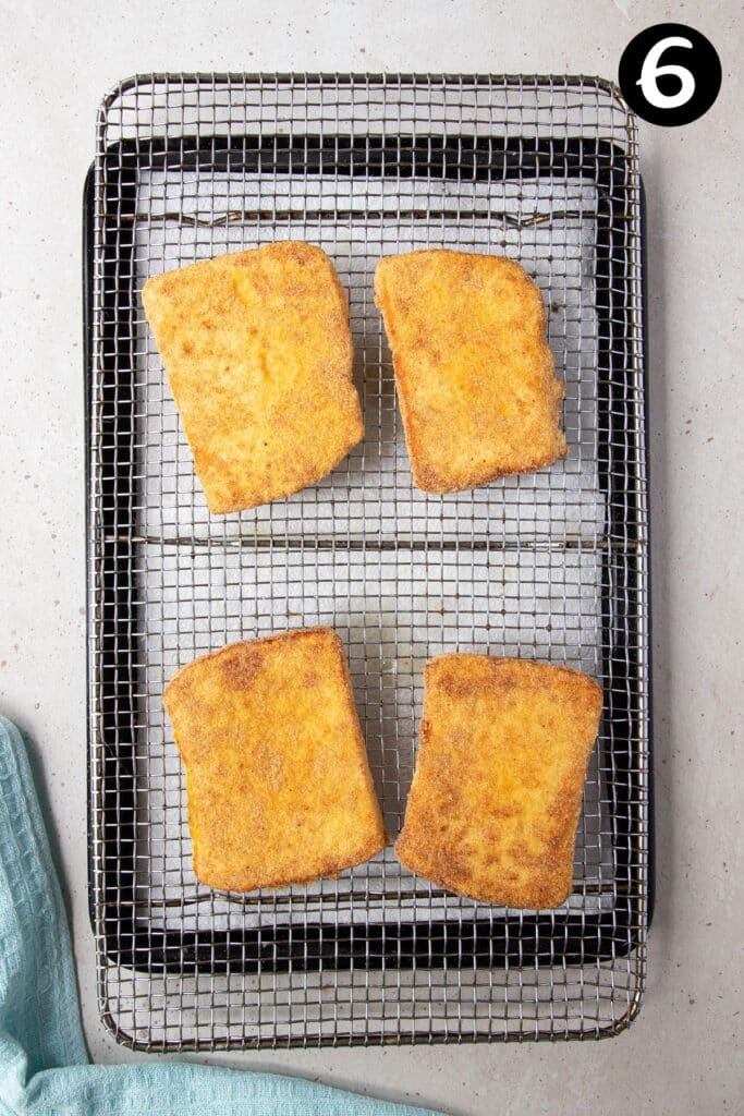 cooked halloumi pieces on a wire tray.