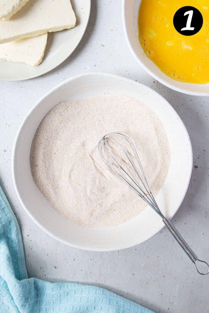 semolina in a bowl with a whisk.