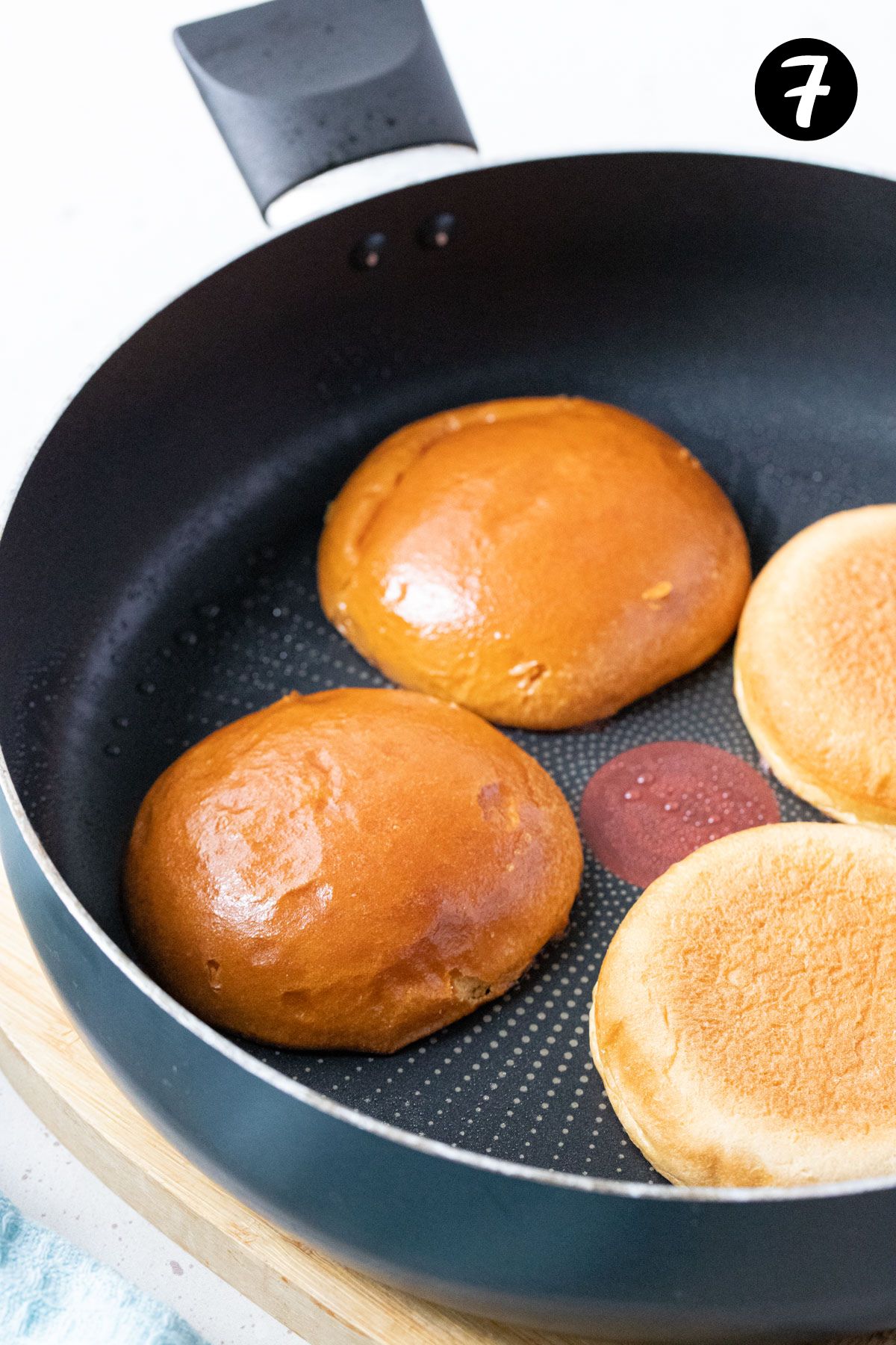 burger buns in a frying pan.