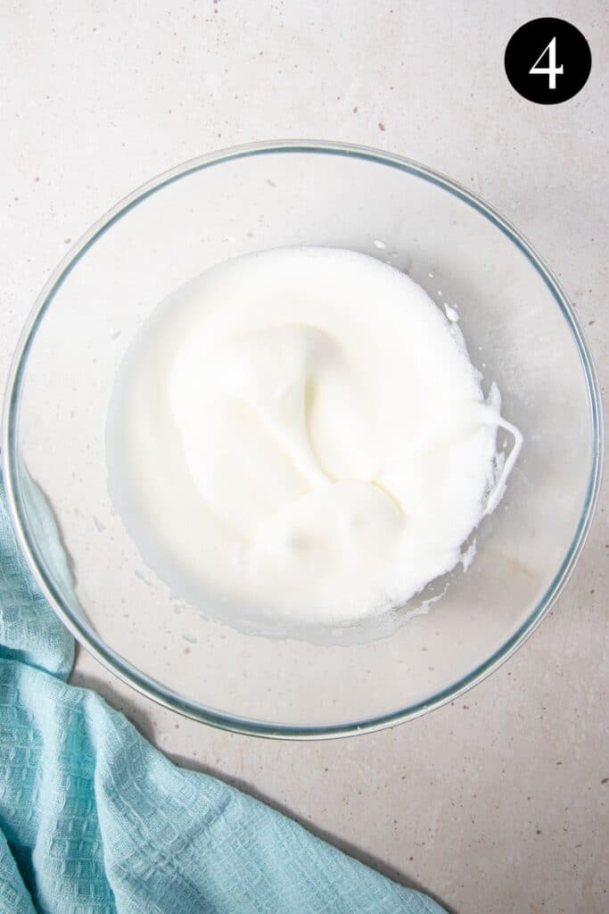 egg whites beaten to soft peaks in a bowl.