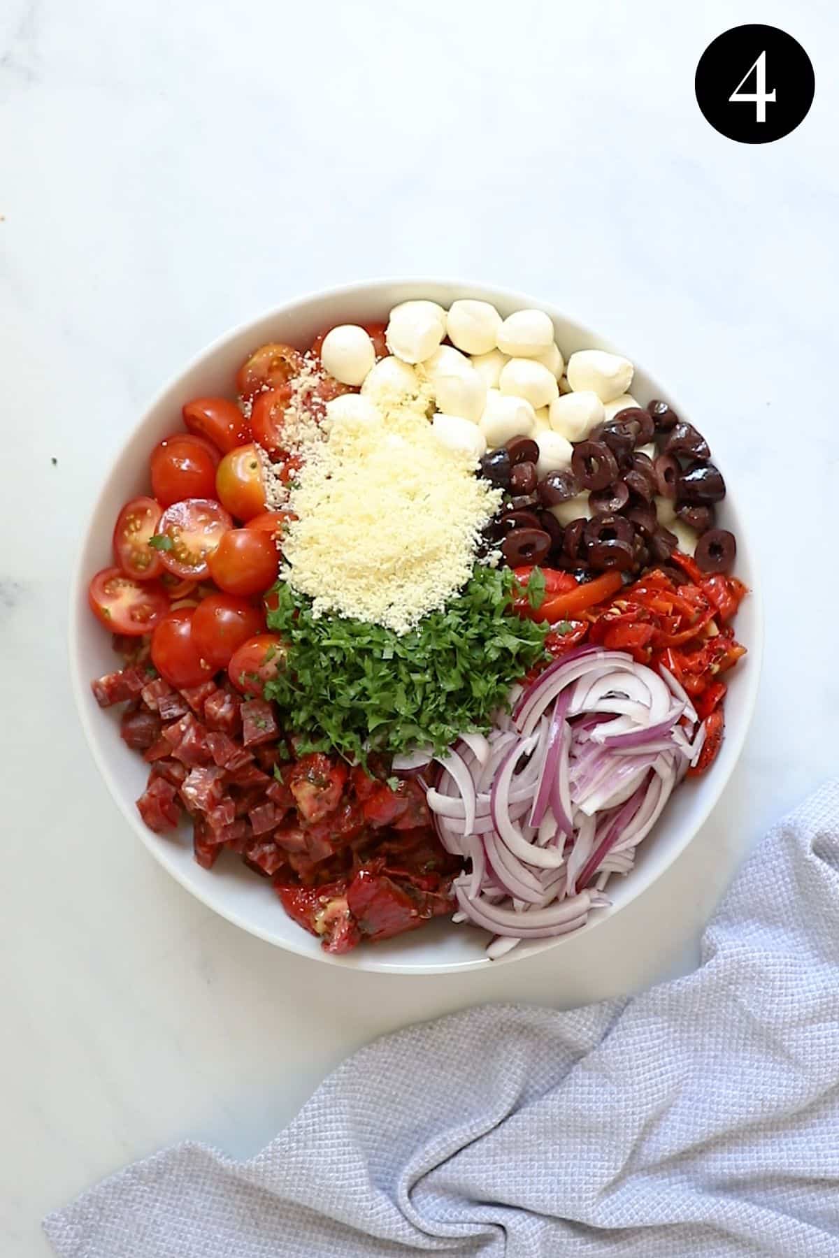 all ingredients for Italian pasta salad, arranged in a bowl.