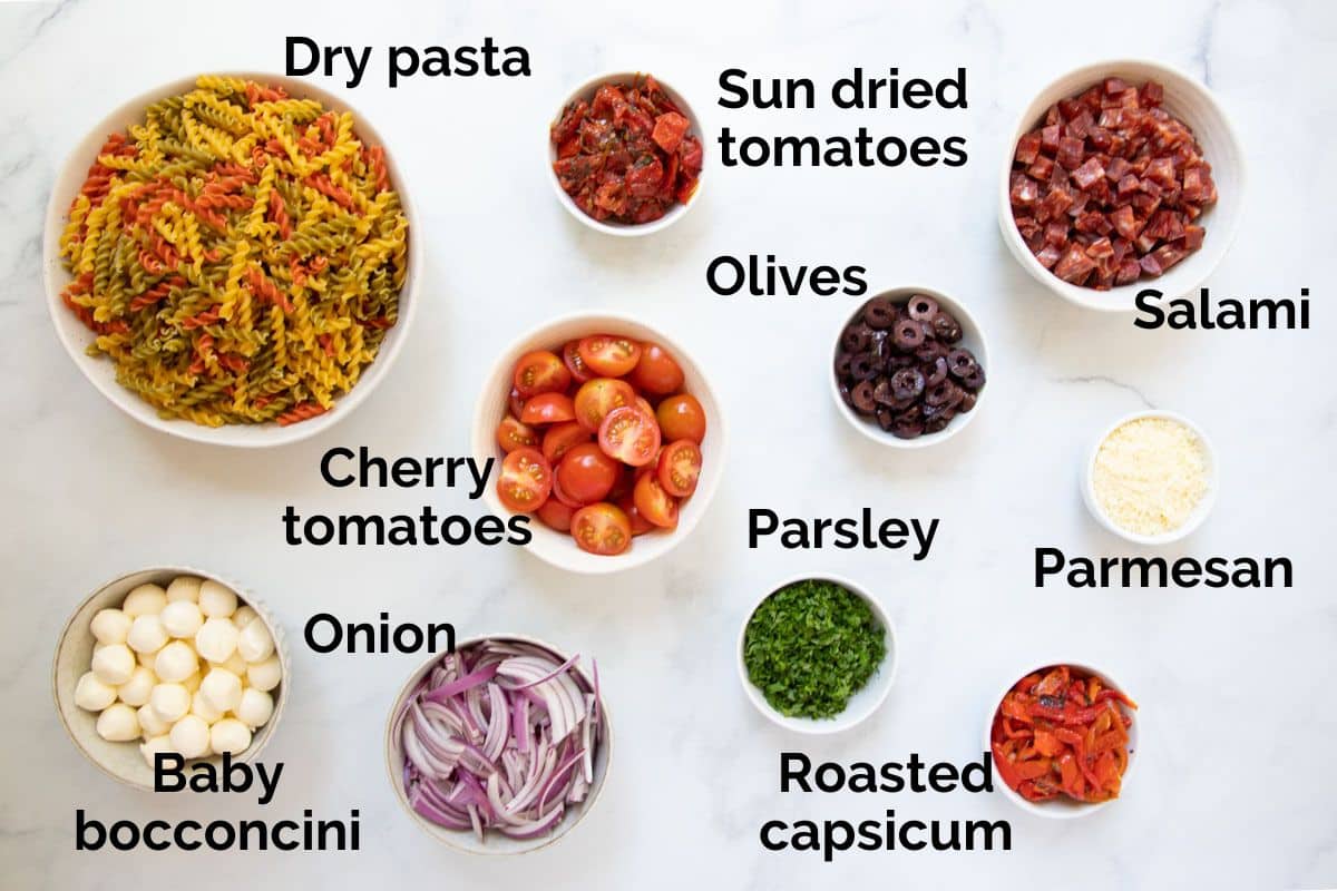 ingredients for Italian pasta salad, laid out on a table.