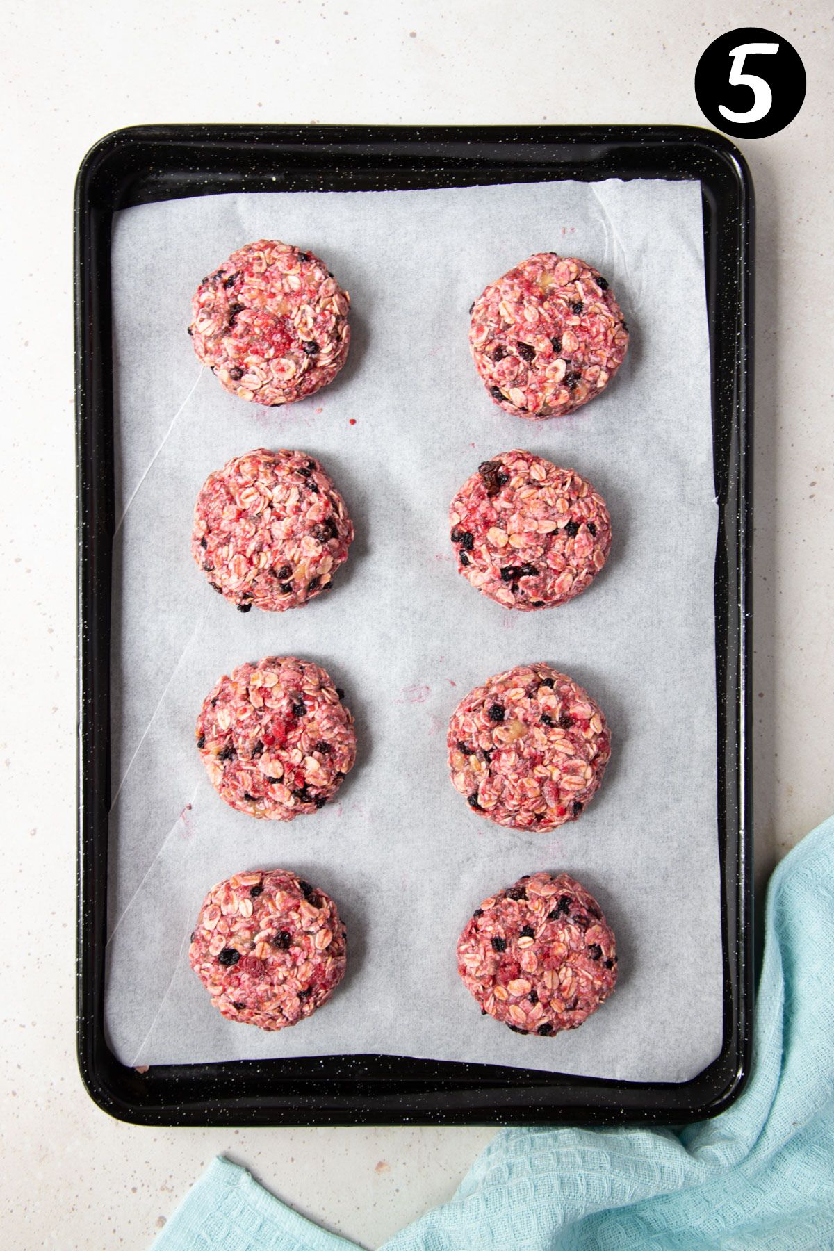 oat cookies on a baking tray lined with paper.