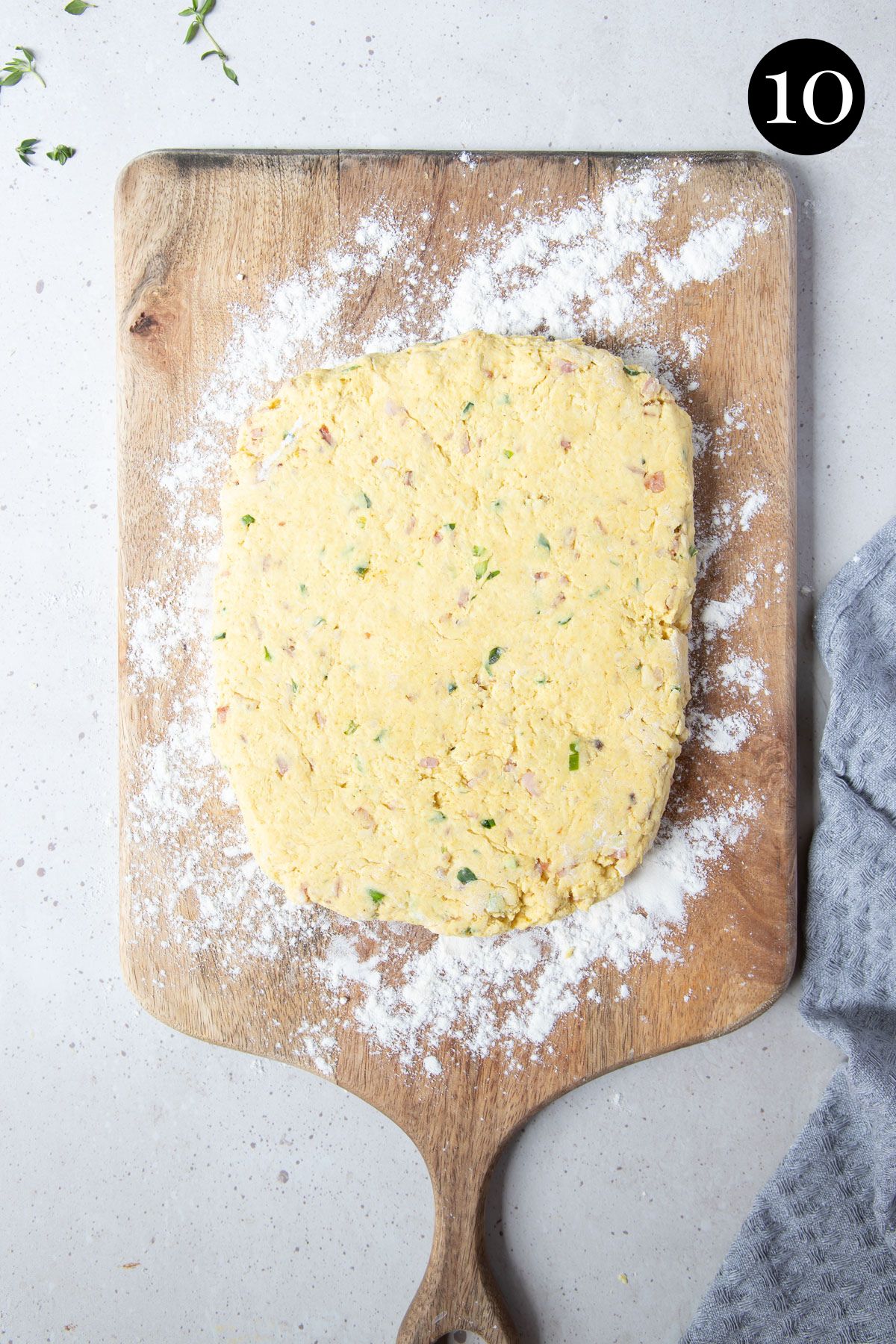 scone dough rolled onto a wooden board.