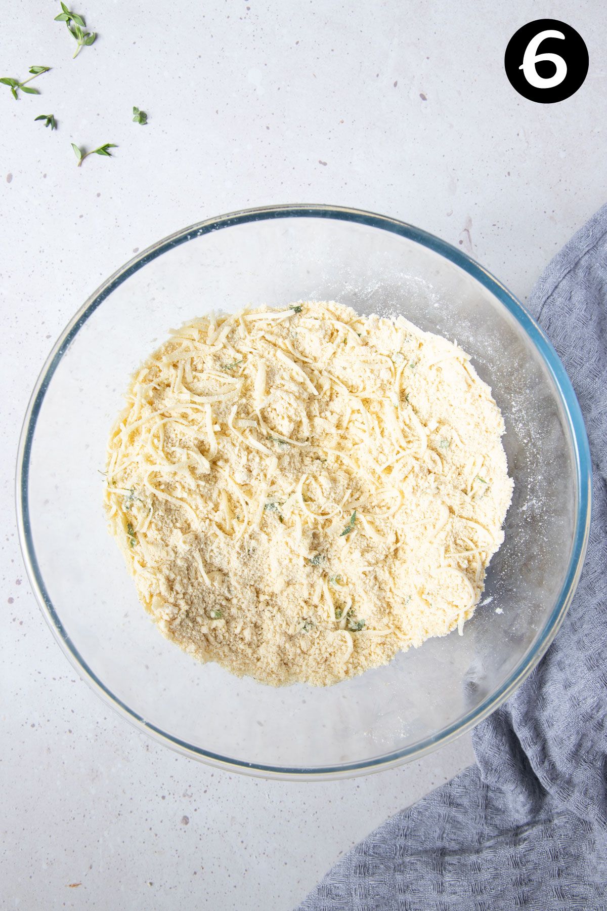 grated cheese mixed with flour mixture in a bowl.