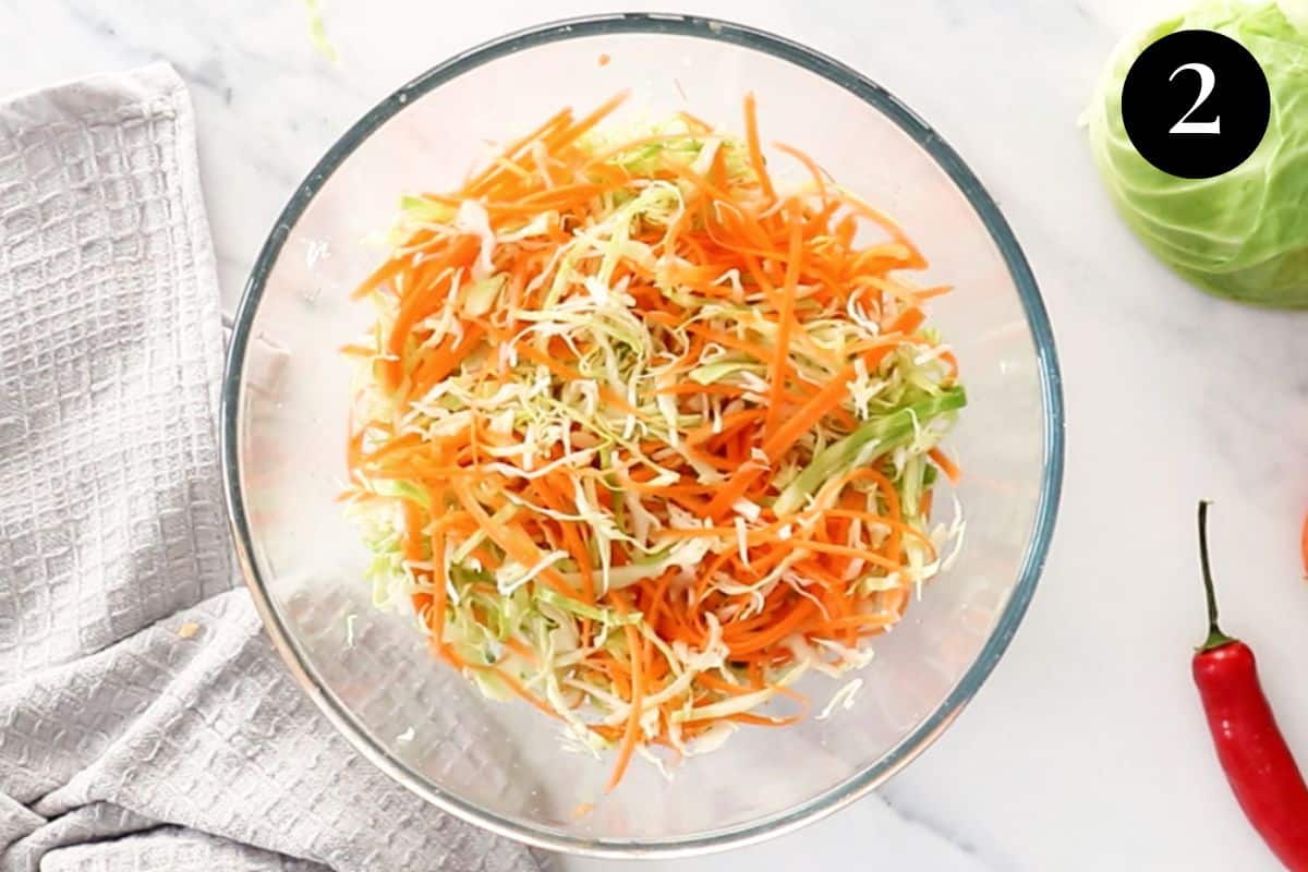 shredded carrot and cabbage in a glass bowl.