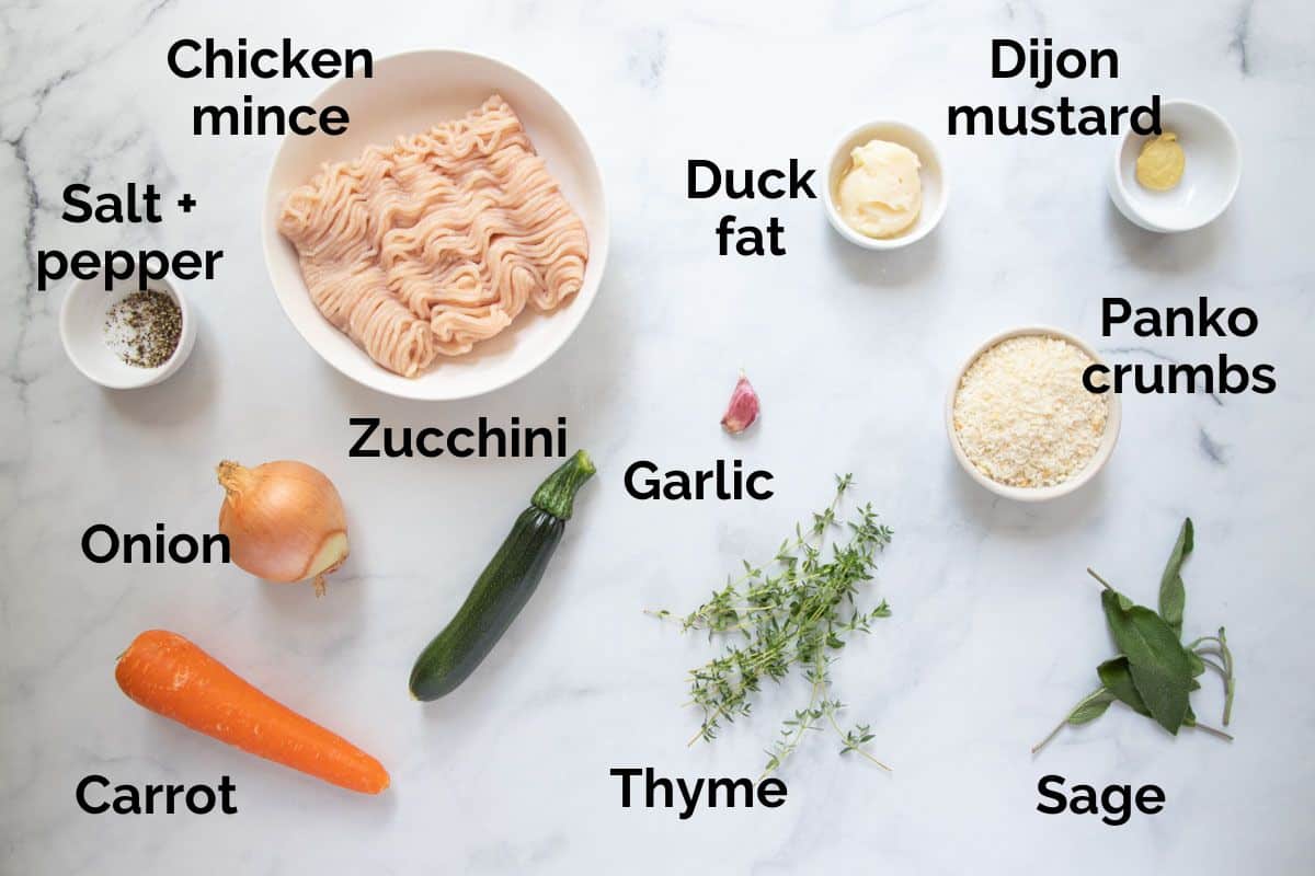 all ingredients for chicken sausage roll filling, laid out on a table.