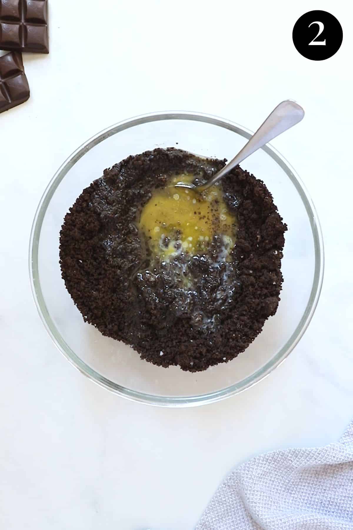 oreo mixture with melted butter in a bowl.