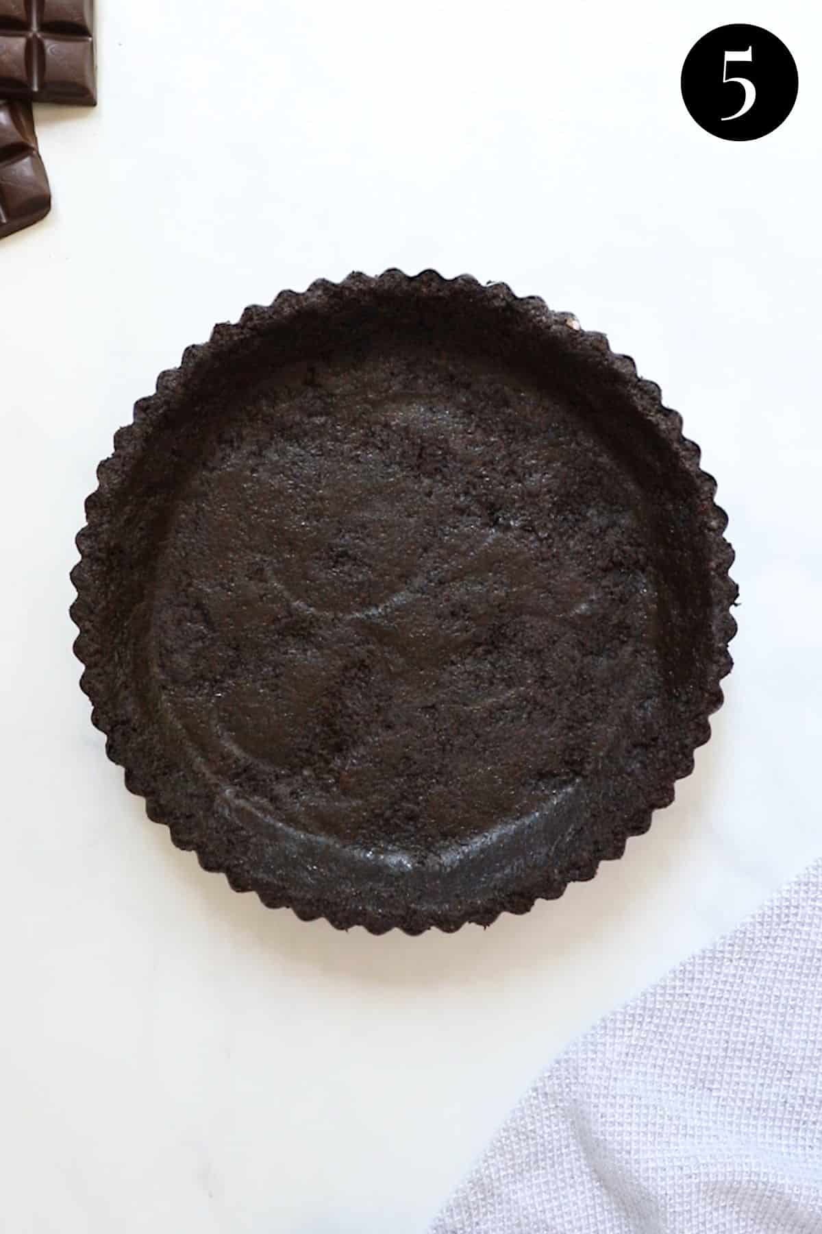 biscuit base pressed into a tart tin.