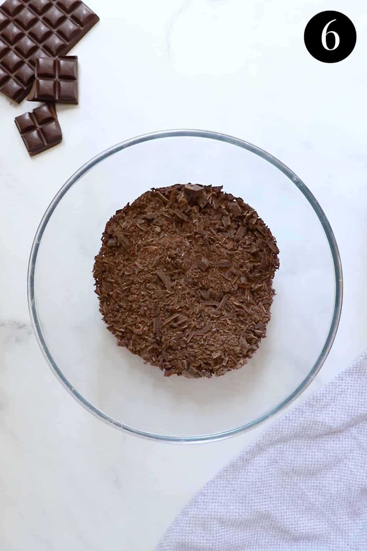 finely chopped dark chocolate in a glass bowl.