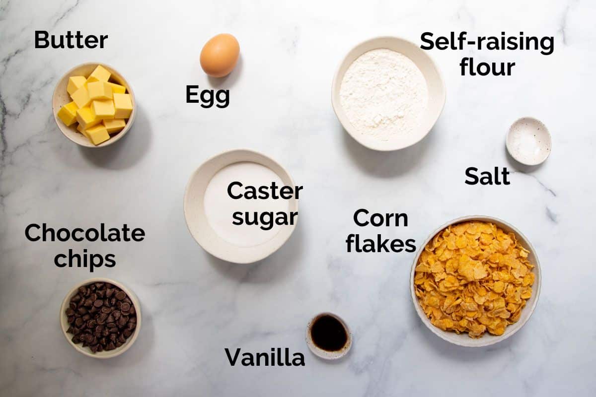 all ingredients for corn flake cookies, laid out on a table.