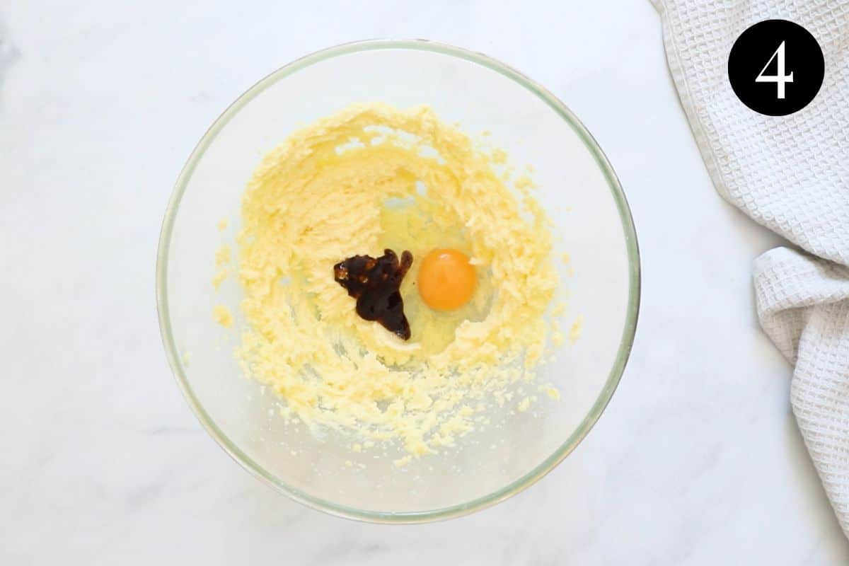 egg and vanilla added to butter mixture in a bowl.