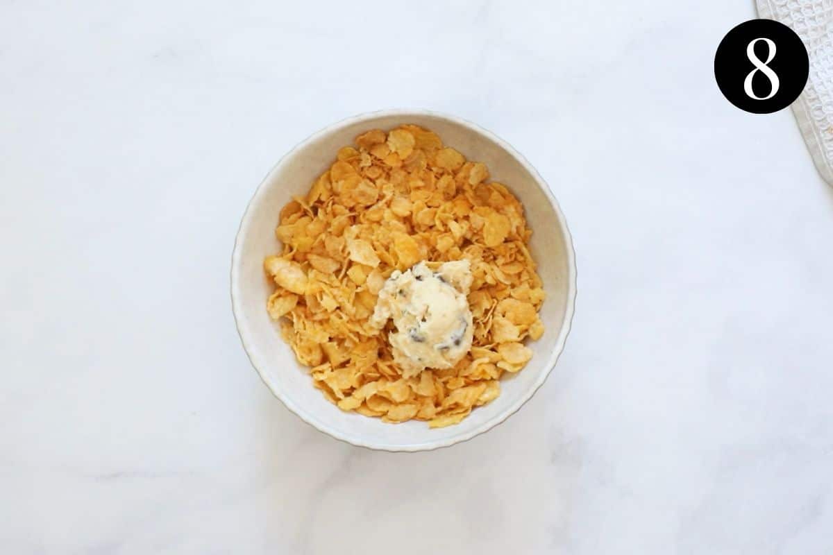 a ball of cookie dough in a bowl of corn flakes.