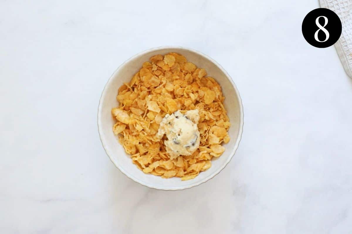 a ball of cookie dough in a bowl of corn flakes.