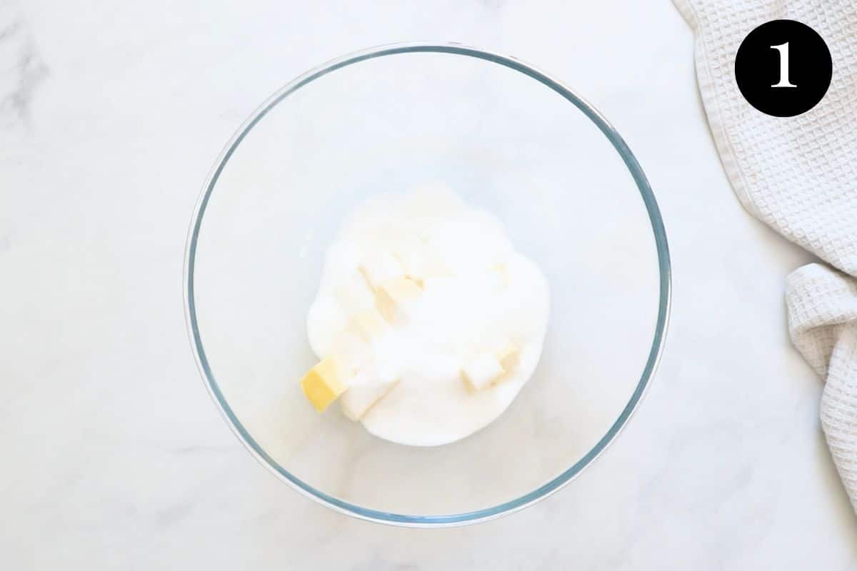 sugar and cubes of butter in a glass mixing bowl.