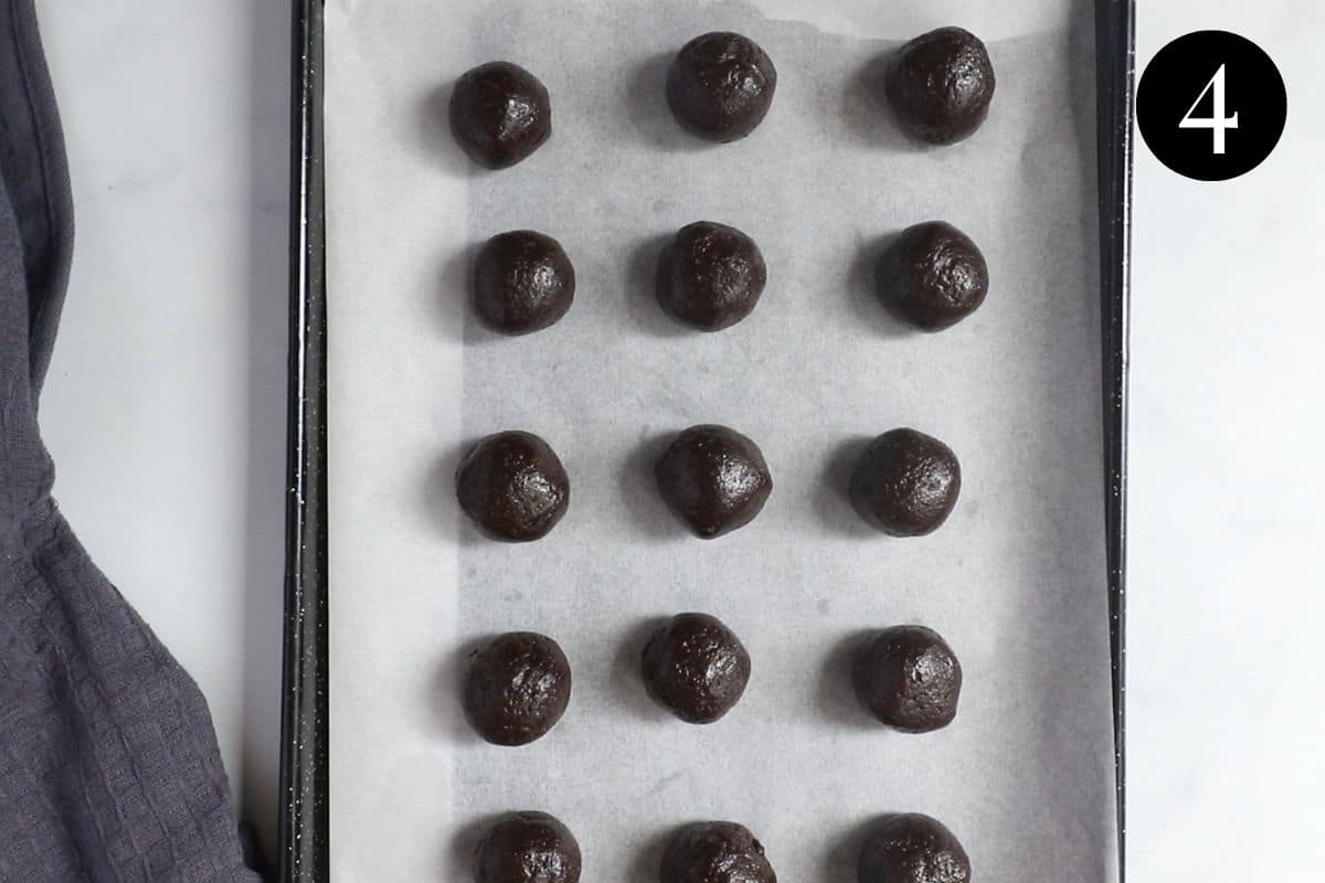 oreo balls on a lined baking tray.