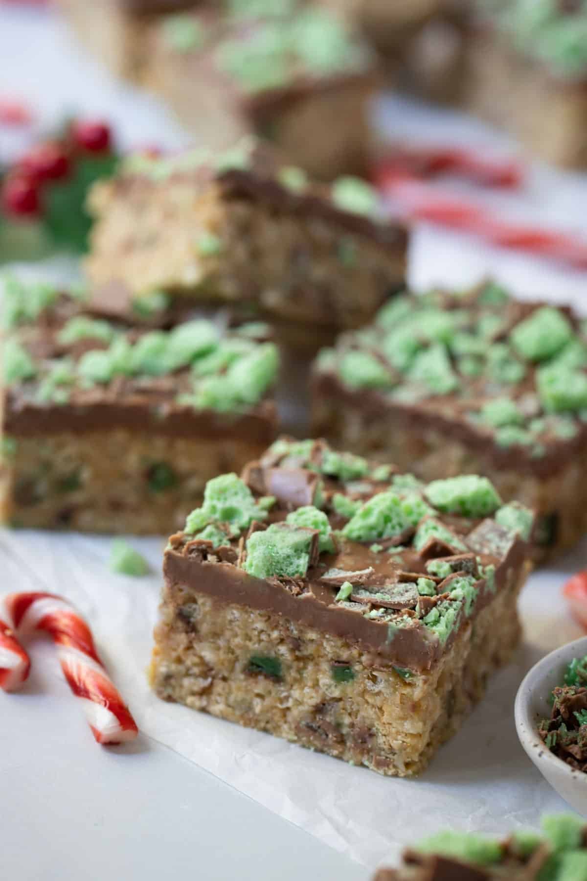 finished slice on a table, topped with pieces of peppermint chocolate.