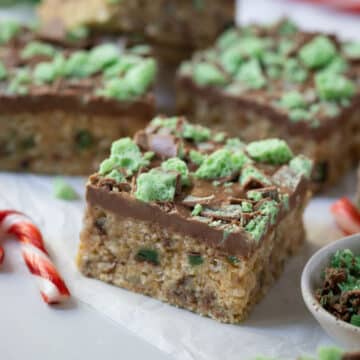 a piece of slice on a table, topped with chocolate.