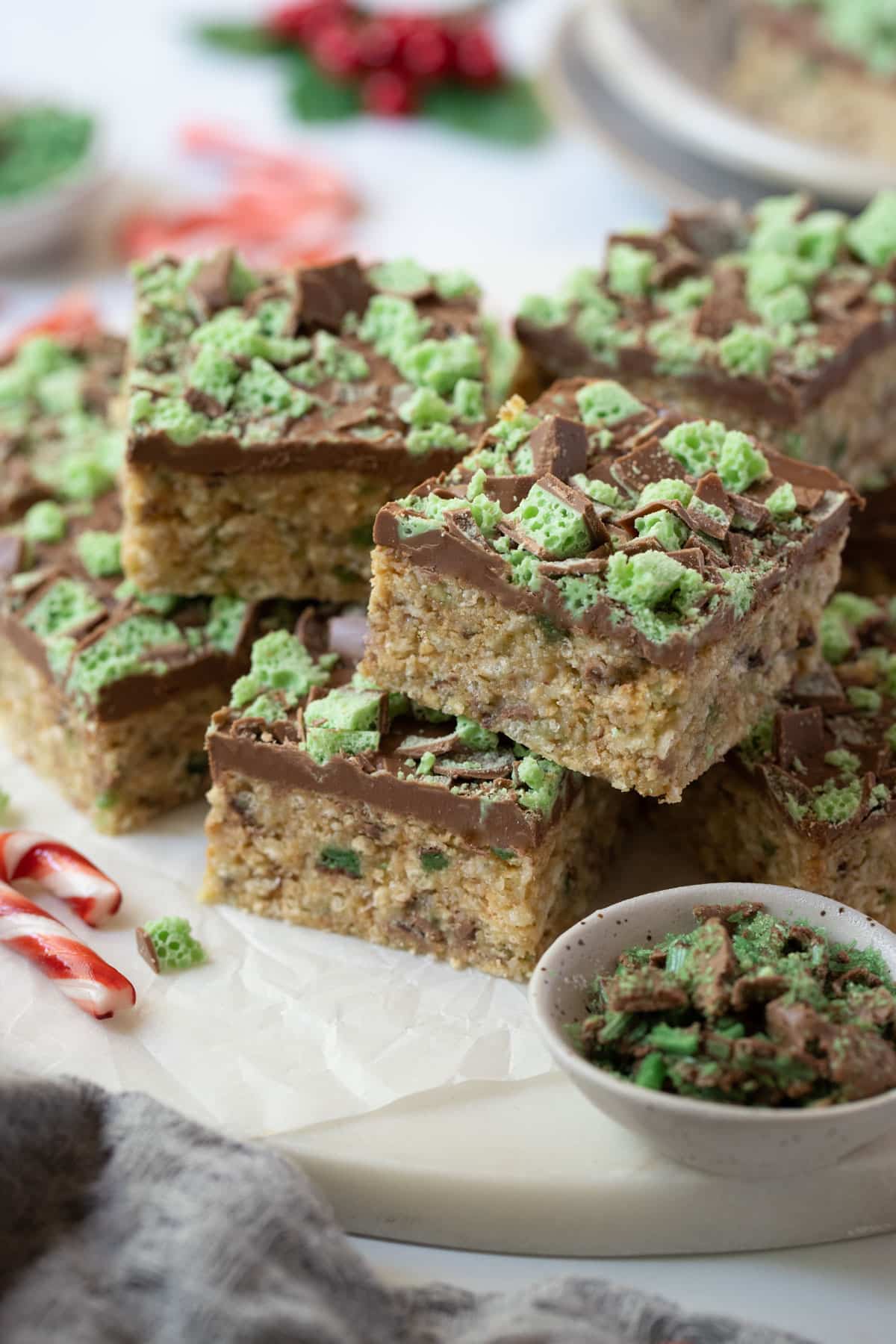 peppermint slice on a tray, with candy canes and crushed chocolate.