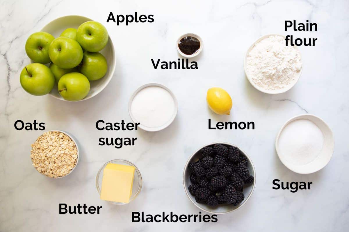 all ingredients for apple and blackberry crumble, laid out on a table.