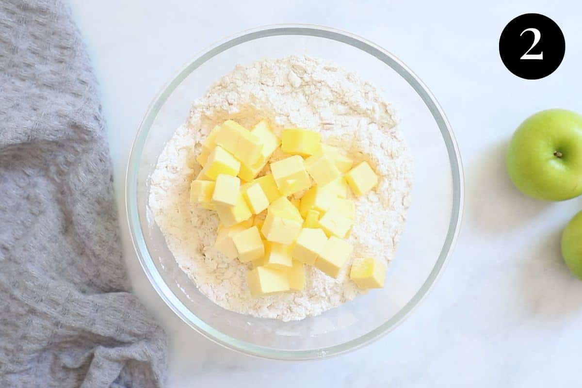 cubes of butter in a bowl with crumble mixture.