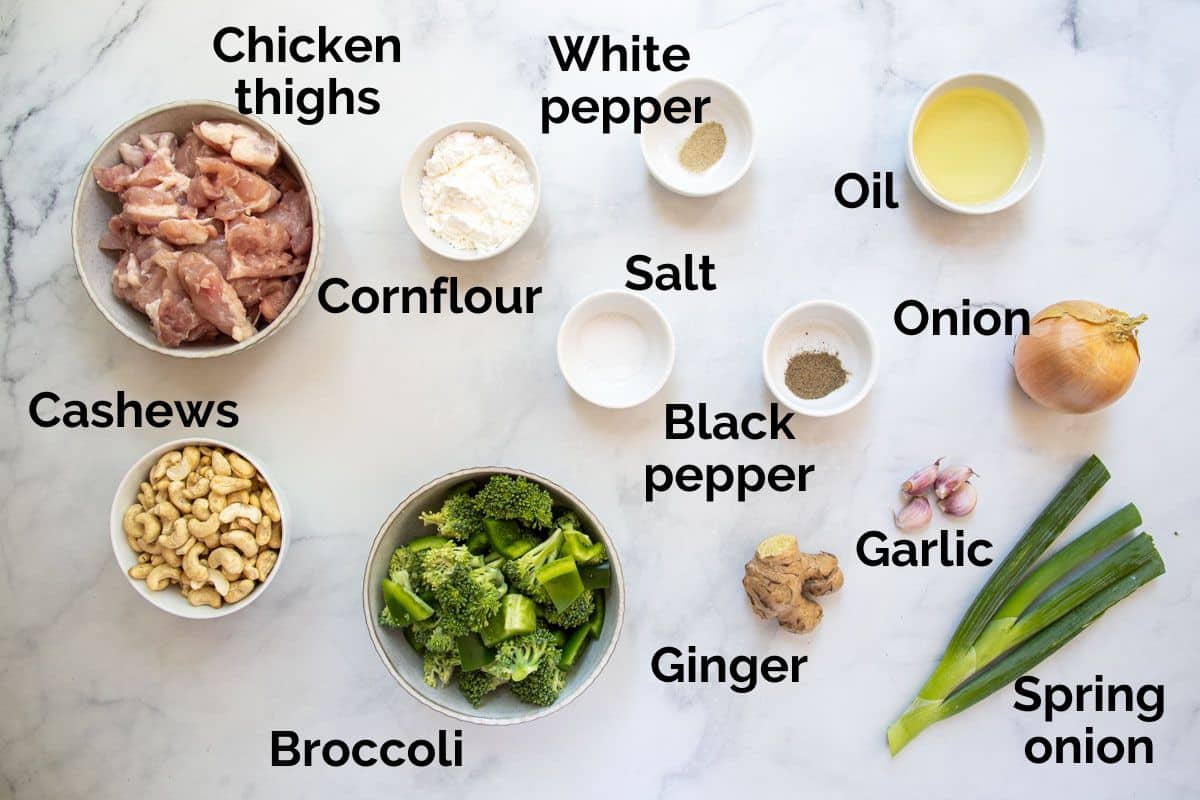 ingredients for chicken cashew stir fry, laid out on a table. 