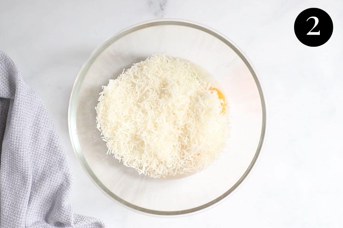 grated cheese and eggs in a bowl.