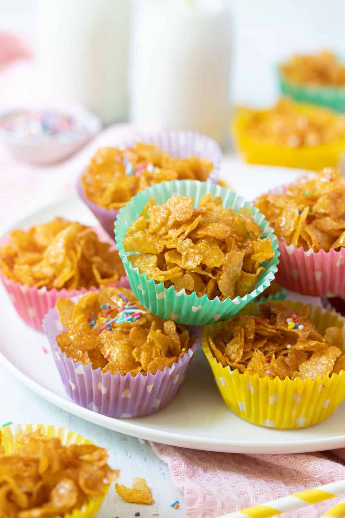 honey joys in colourful paper cases, stacked on a table.