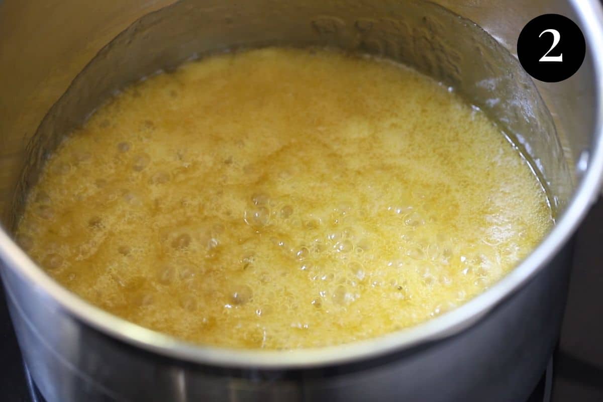 butter and honey mixture bubbling and foaming in a saucepan.