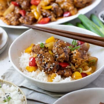 sweet and sour pork in a bowl with rice.
