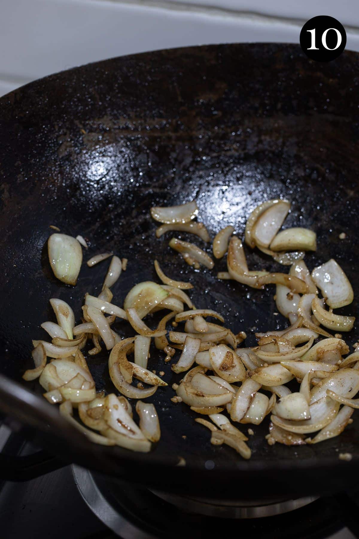 onion and garlic cooking in a wok.