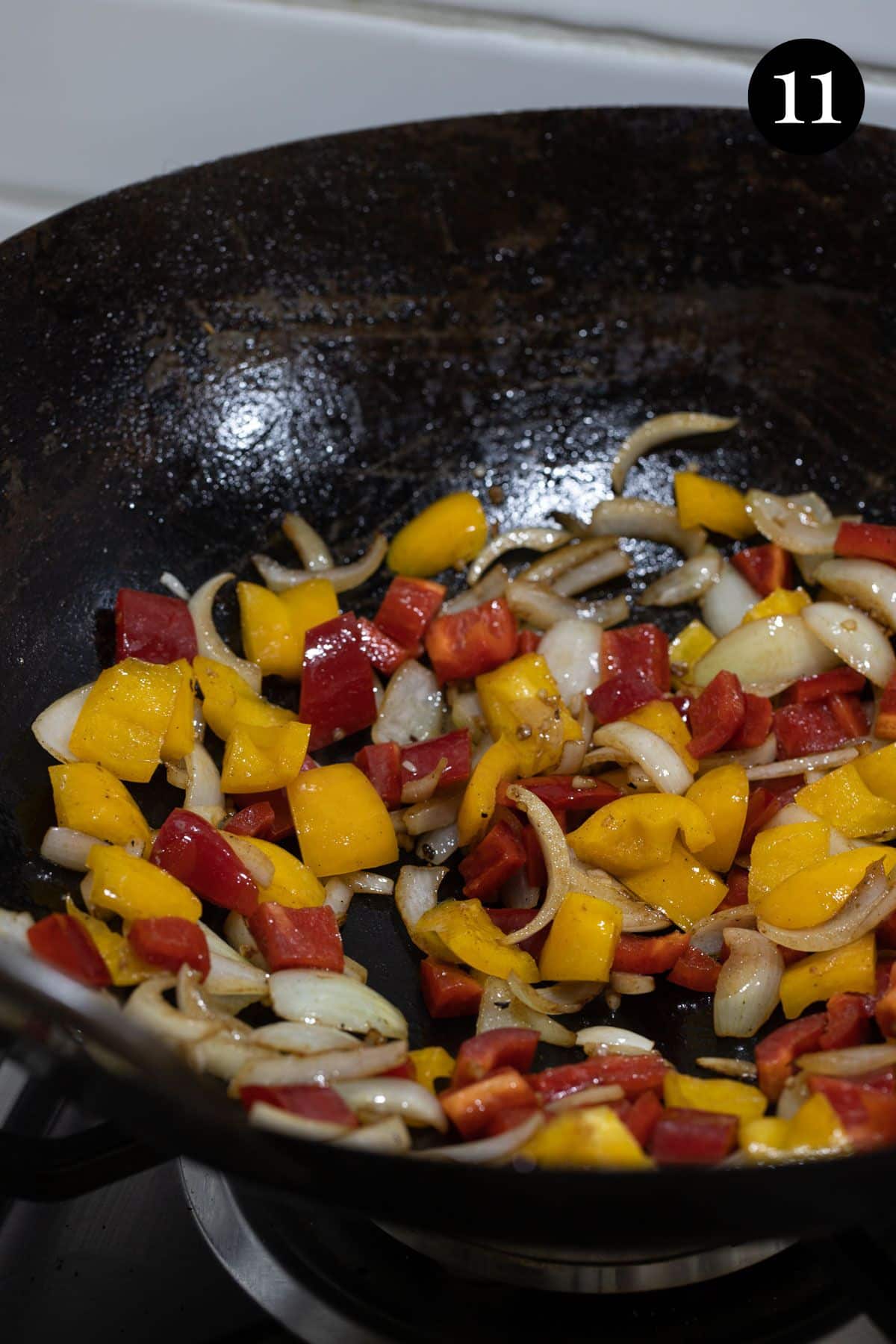 capsicum, pineapple and onion cooking in a wok.