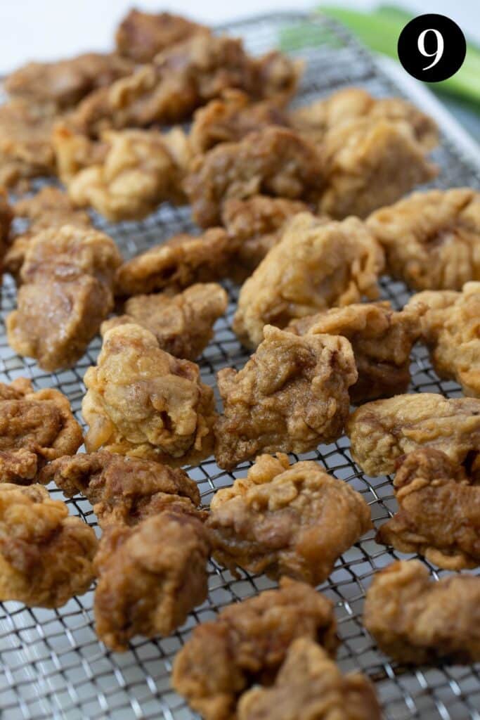 pieces of battered pork, resting on a wire rack.