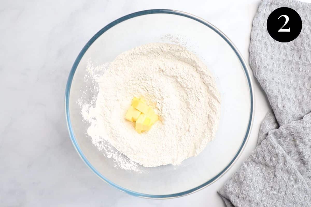 a mixing bowl with flour and butter.