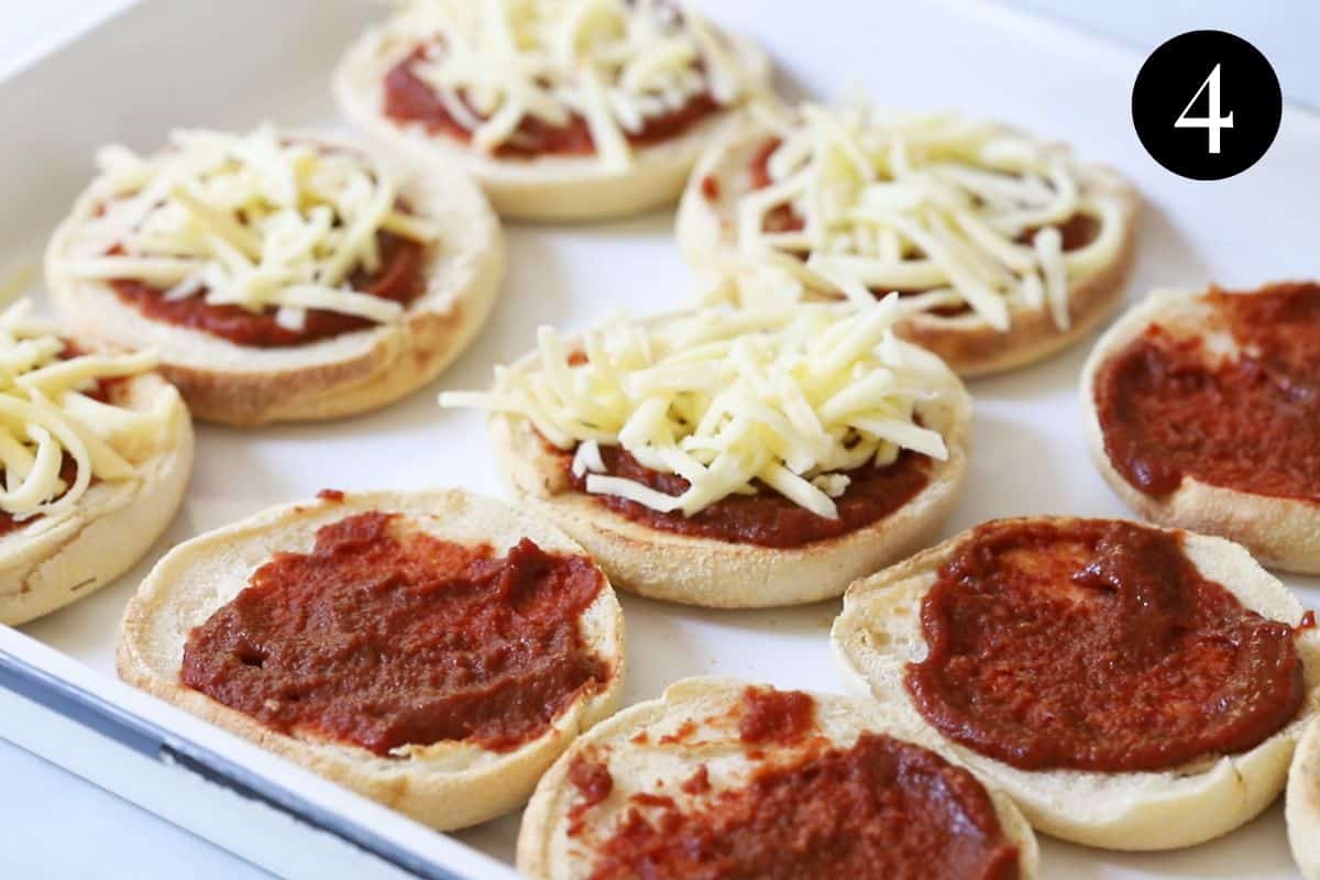 shredded cheese on top of English muffins.