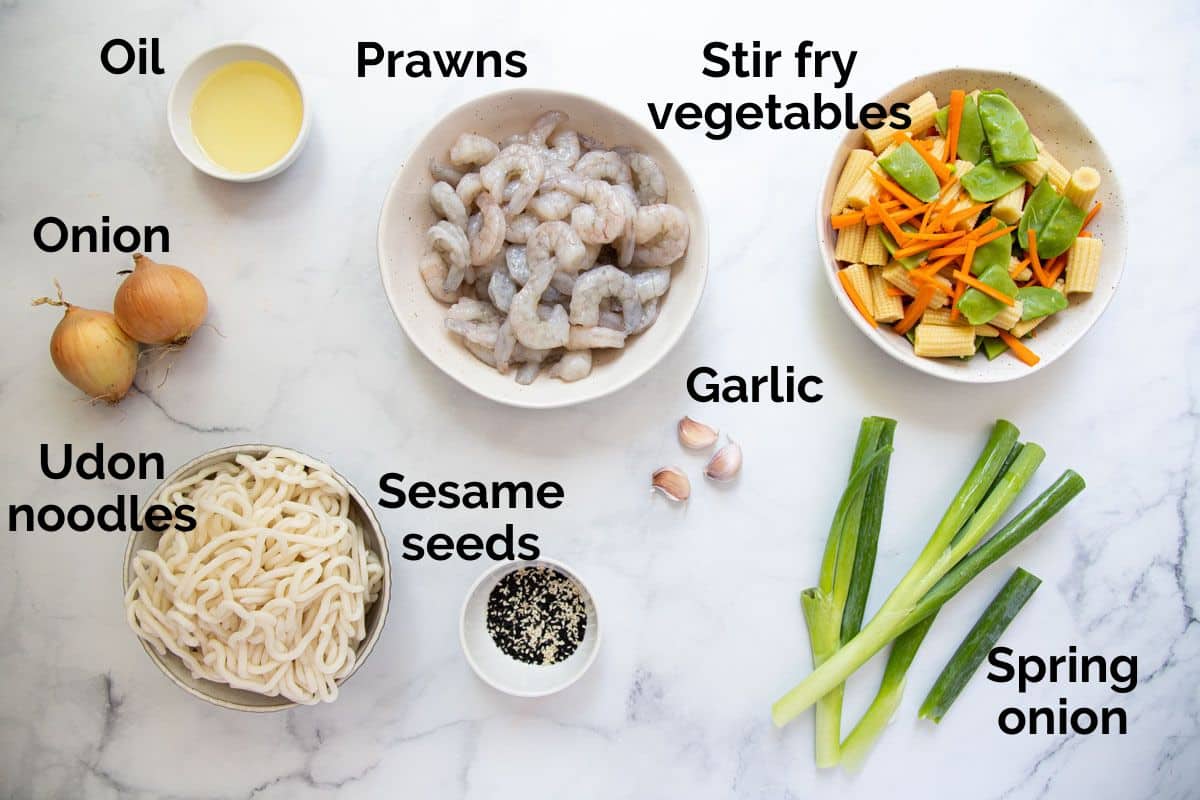 ingredients for prawn noodle stir fry, laid out on a table.