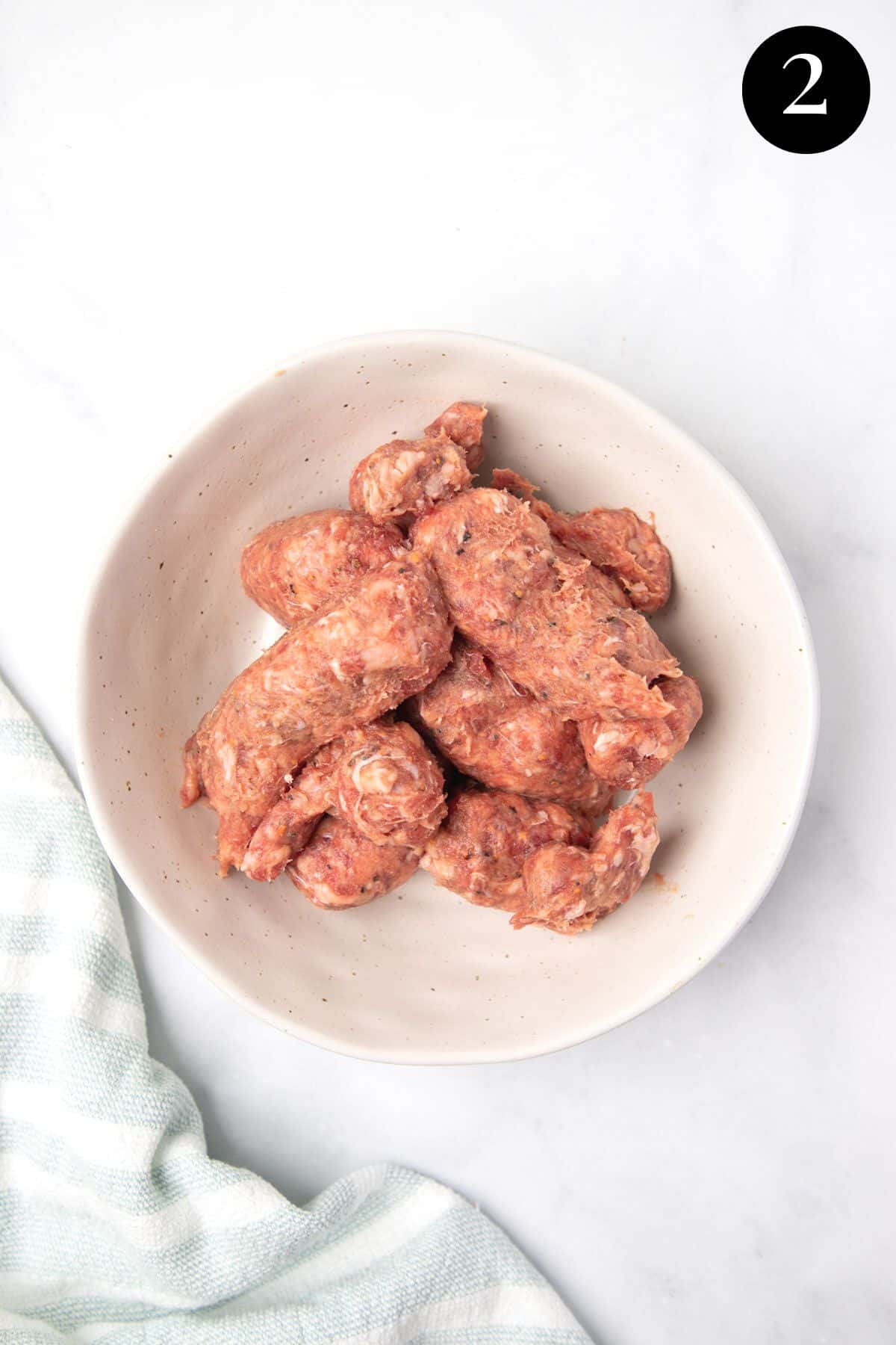 sausage meat in a bowl with casing removed.