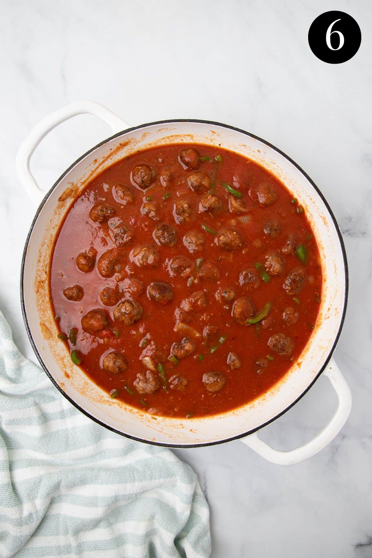 sausages in tomato sauce, in a pan.