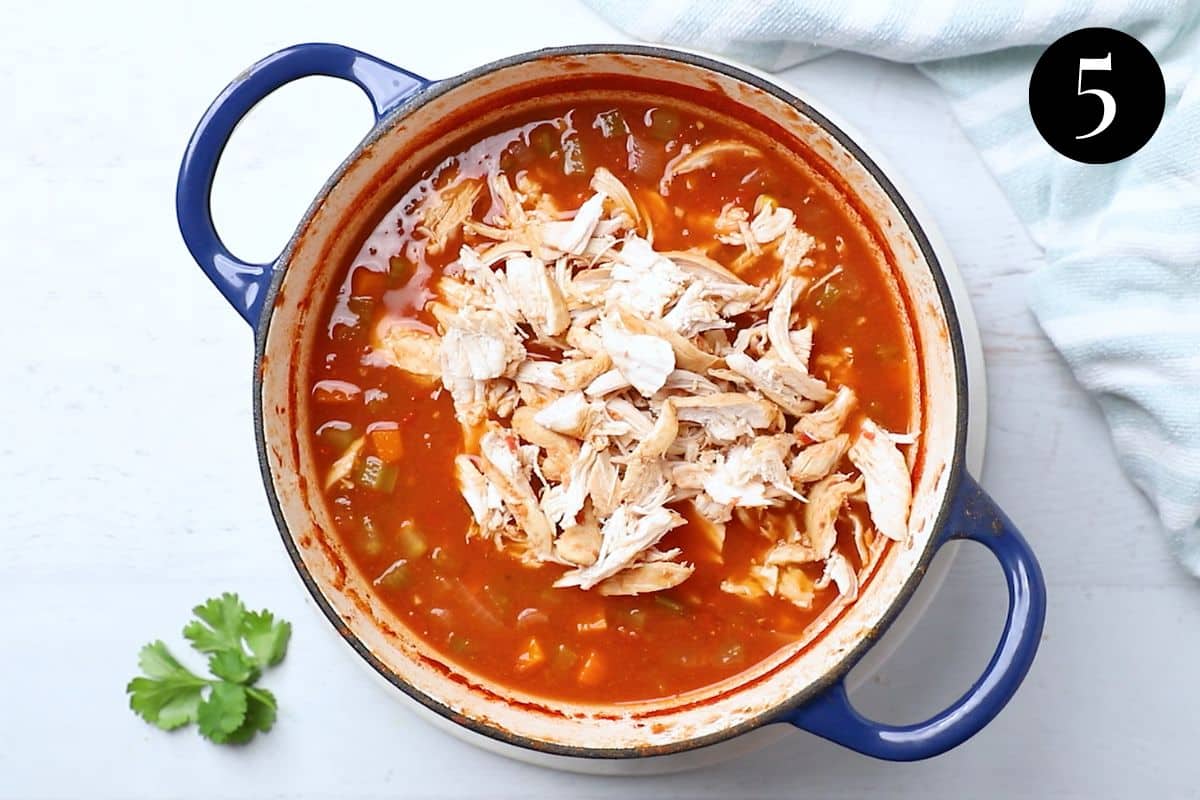 shredded chicken and soup in a pot.