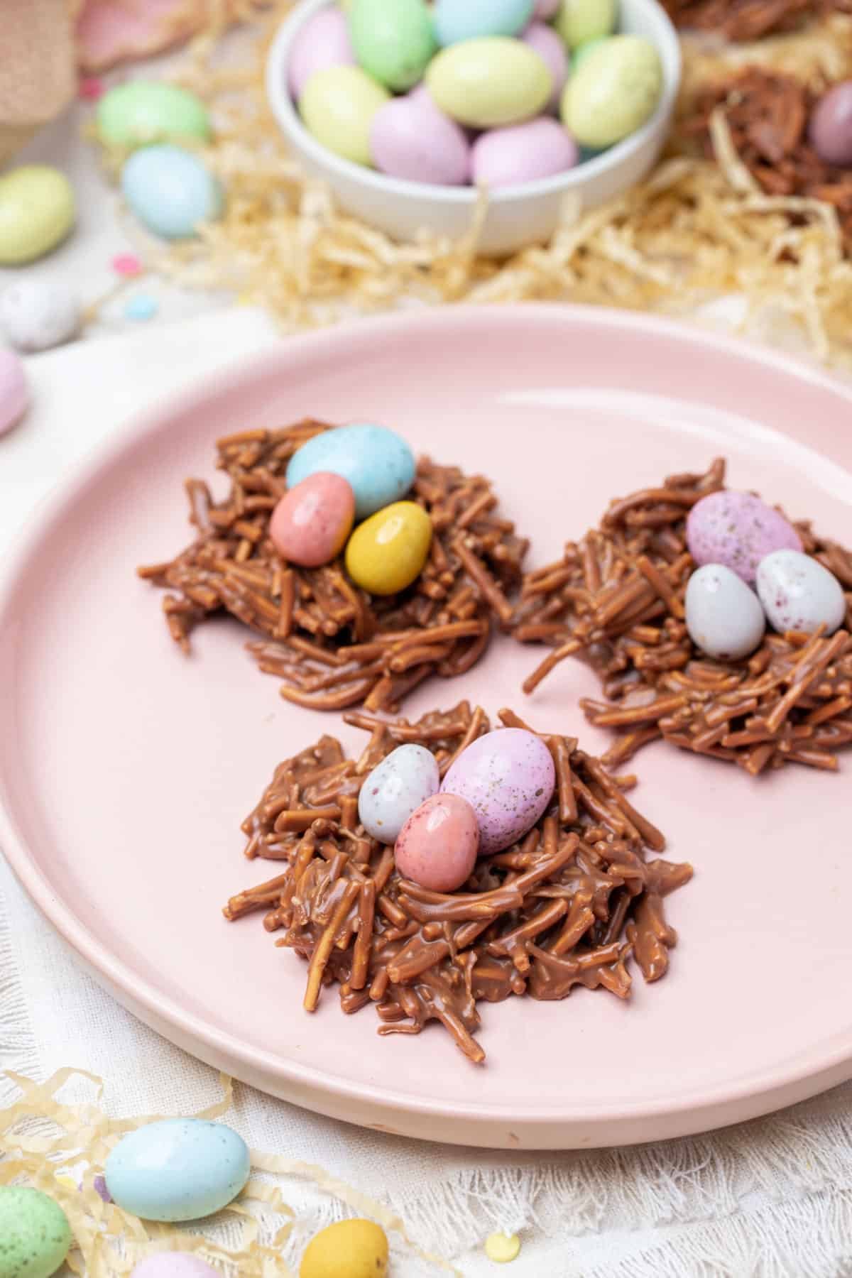 a plate with chocolate nests, topped with speckled Easter eggs.