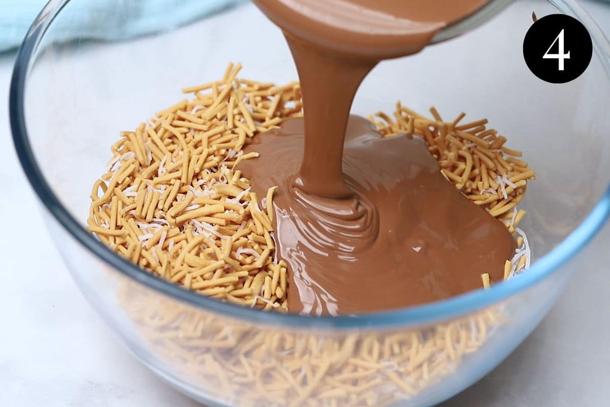 melted chocolate being poured over noodle and coconut mixture.