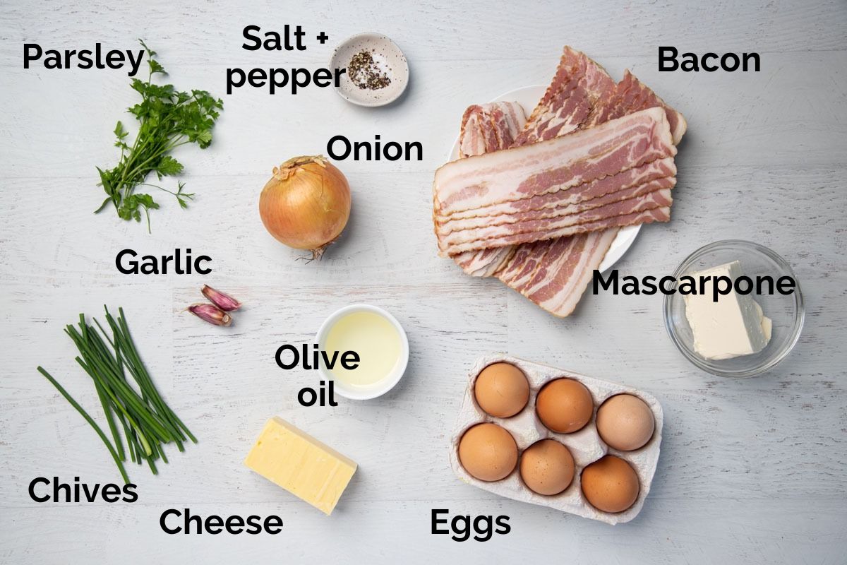 all ingredients for egg and bacon pie filling, laid out on a table.
