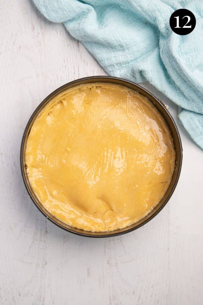 a pie topped with pastry in a baking tin.