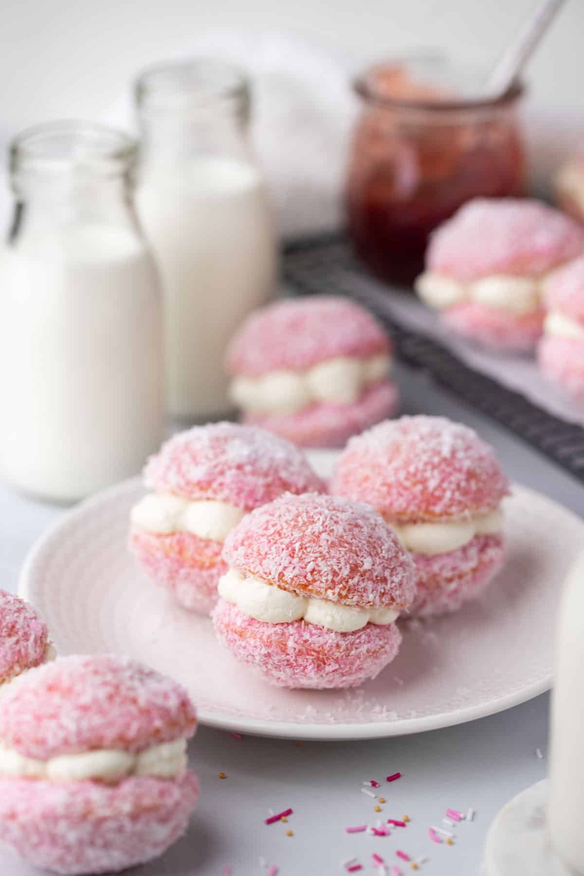 pink jelly cakes filled with cream, on a white plate.