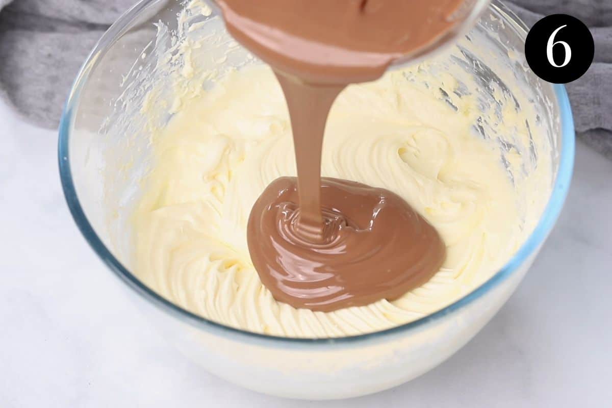 melted chocolate being poured over cream cheese mixture in a bowl.