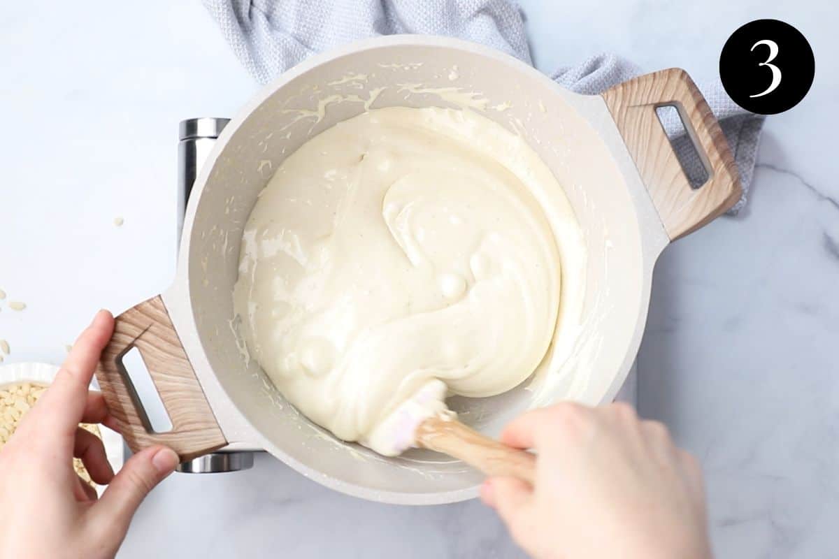 melted marshmallow mixture being stirred in a pot.