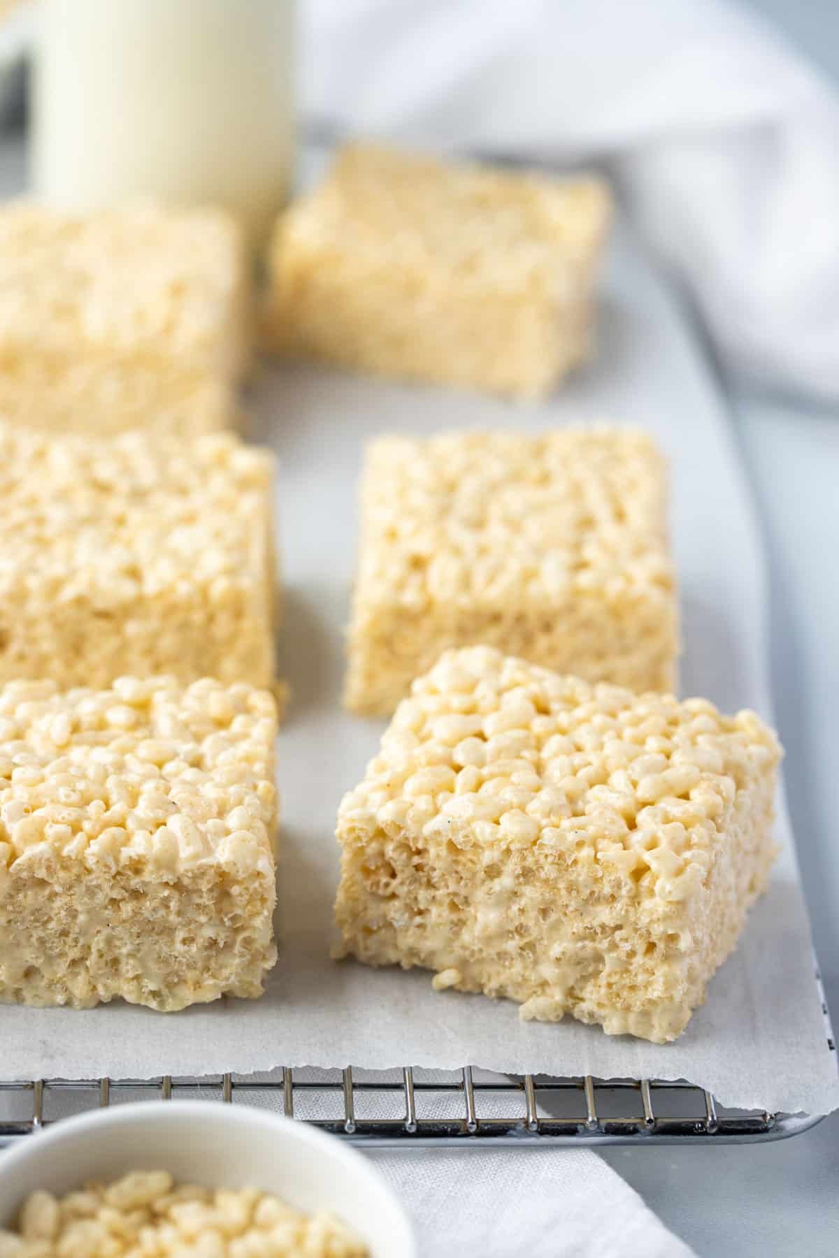 rice bubble marshmallow slice cut into pieces on a rack.