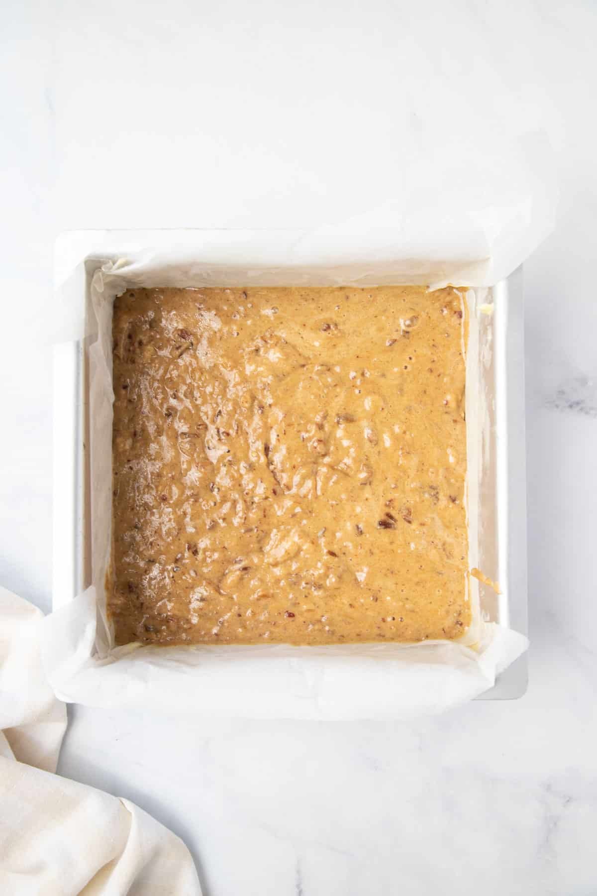 pudding batter in a square baking tin.