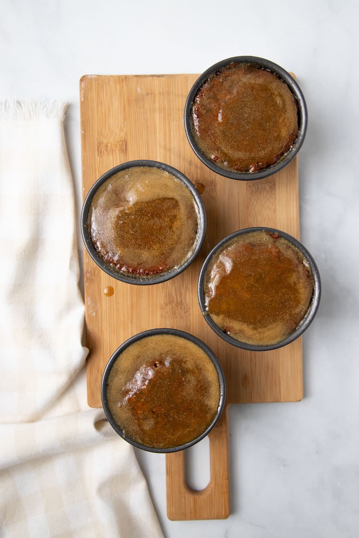 puddings soaking in caramel sauce.